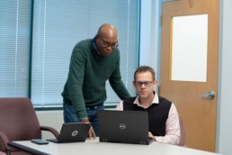 2 men working at computer